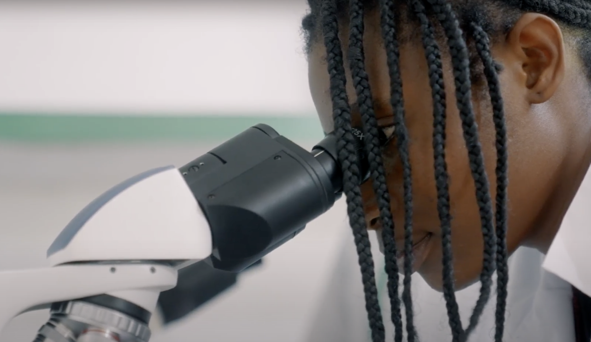 scholarship-student Female veterinary medicine student uses microscope during class